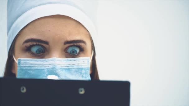 Adorable femme médecin a lu quelques mauvaises nouvelles et regarde avec peur et désespoir dans ses yeux . — Video