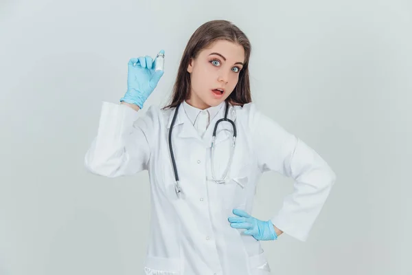 Muito jovem estagiária segurando uma garrafa de comprimidos, parecendo confiante . — Fotografia de Stock