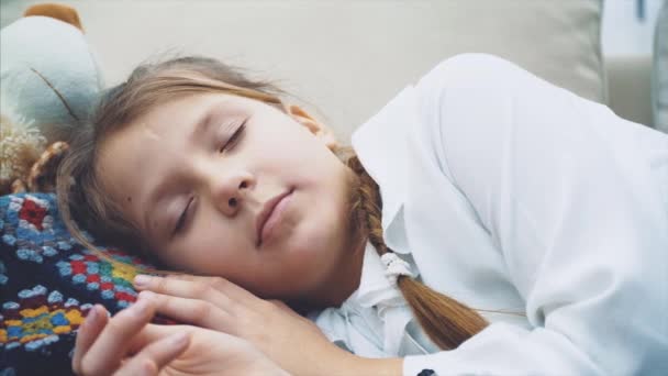 Sweet charming kid is sleeping on her big white teddy-bear. — Stock Video