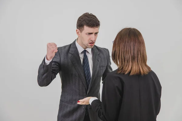 Boss and secretary having serious talk. Strict boss is threatening his young employee with a fist. — Stock Photo, Image