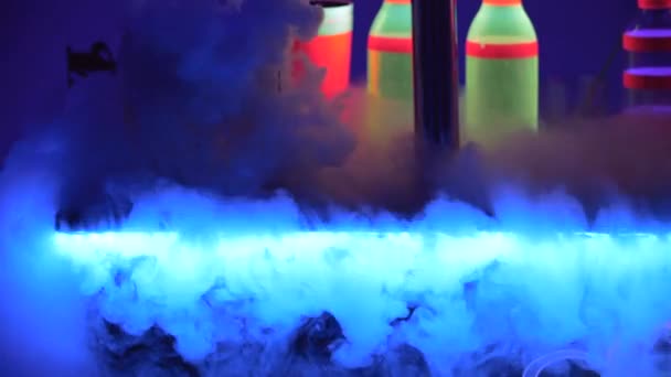 Close up. Crop. Barman is pouring dry ice on bar and makes fabulous show. Colorful lights led. Slow motion. 4K. — Stock Video