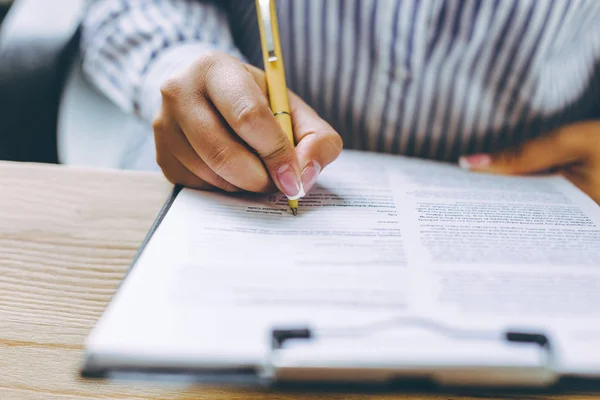 Recorte de una mano femenina firmando un contrato de negocios en primer plano . — Foto de Stock