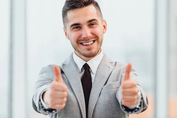 Cropped photo of successful businessman with thumbs up celebrating his victory, smiling at the camera. — Stock Photo, Image