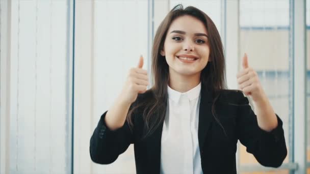 Business woman smiling for camera with her thumb fingers up, isolated on white panoramic background. Close up. Copy space. 4K. — Stock Video