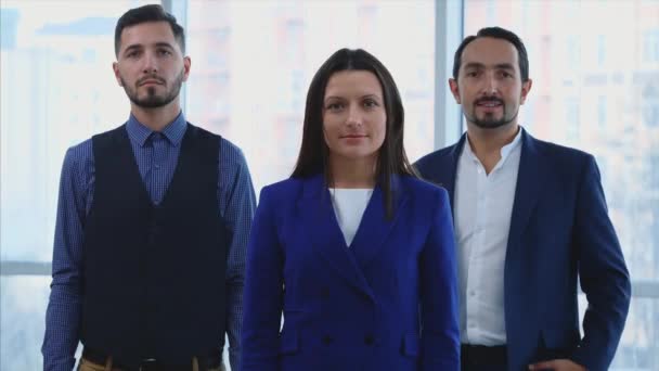 Three business people are standing with crossed arms. They are giving cordinal smile. Close up. Copy space. 4K. — Stock Video