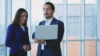Business workers are discussing issue on the forefront. Man is on the phone on the light blurred background. Copy space. Close up. 4K.