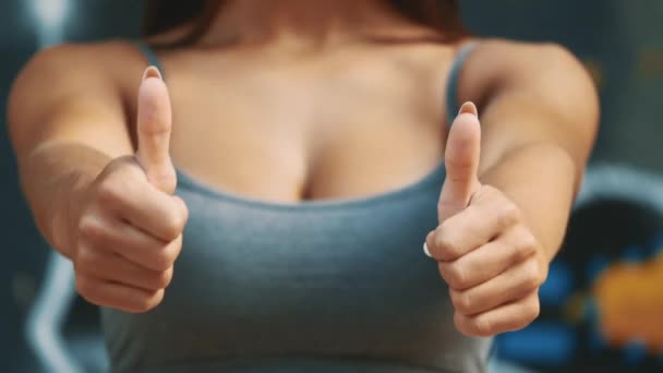 Ferme là. Sexy fitness girl montre pouces vers le haut. Espace de copie. 4K . — Video