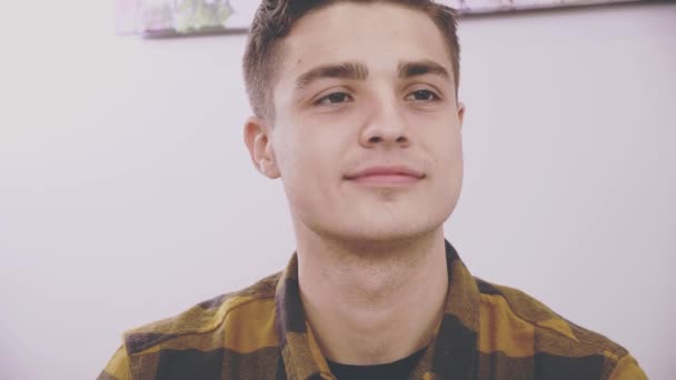 Adorable boy is sitting at the table in cafe. He is communicating with his girlfriend. Sincere smile. Close up. Copy space. — Stock Video