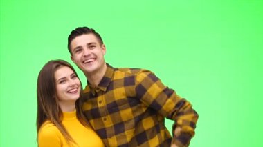 Young happy couple is showing something together. Close up. Copy space. 4K.