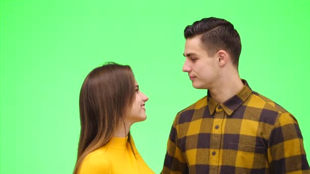 Tender kärleksfullt par ler uppriktigt och myser på en grön bakgrund. Närbild. Uppfattat utrymme. 4k. — Stockvideo