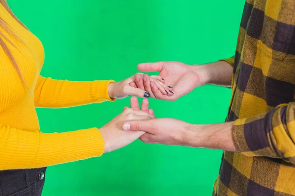 Cropped shot of hands in hands together over green background. — ストック写真