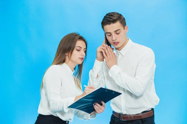 Businessman signing contract in place that his secrelary showed him, while talking on phone. — 图库照片