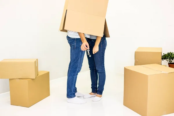 Cropped shot of family with cardboard boxes on their heads in a fun moving day isolated on white.