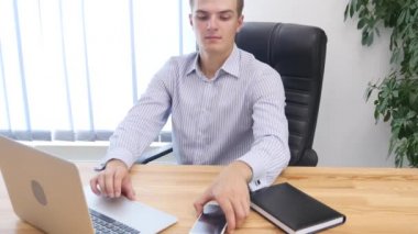 Businessman types at desktop keyboard in workspace. Close up. Copy space. 4K.