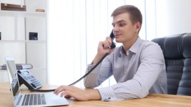 Businessman types at desktop keyboard in workspace. Close up. Copy space. 4K.