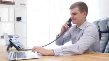 Businessman types at desktop keyboard in workspace. Close up. Copy space. 4K.