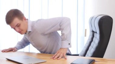 Businessman types at desktop keyboard in workspace. Close up. Copy space. 4K.