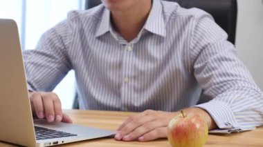 Businessmans hands type at desktop keyboard in workspace. Blurred background. Close up. Copy space. Crop. 4K.