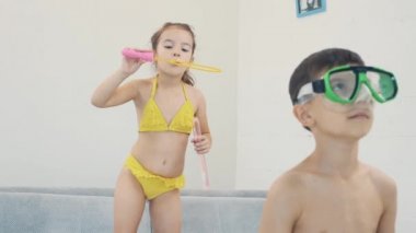 Adorable and little girl with pony-tail blows bubbles. Close up. Copy space. 4K.