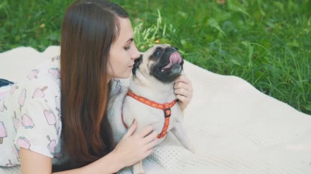 Smiling lady is taking free time with her dog. Woman relaxing in the nature with her little pug dog. Crop. Close up. Copy space. 4K. — Αρχείο Βίντεο