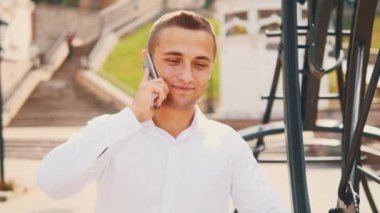 Successful, confident business man is on the phone, isolated, street background. Close up. Copy space. 4K.