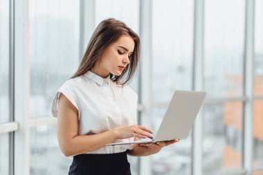 Researcher in formal business attire looking for information online, isolated on white.