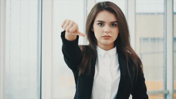 Business woman shows disapproval for camera with her thumb finger down, isolated on white panoramic background. Close up. Copy space. 4K. — Stok video