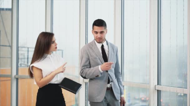 Two business people are going along on white blurred panoramic background. Blurred beginning. Close up. Copy space. 4K. — 비디오