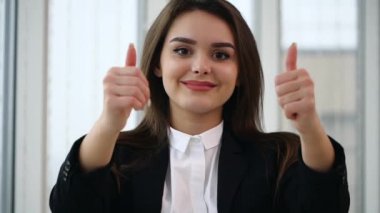 Business woman smiling for camera with her thumb fingers up, isolated on white panoramic background. Close up. Copy space. Slow motion. 4K.