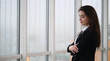 Business woman is smiling, isolated on white panoramic background. Slow motion. Close up. Copy space. 4K.