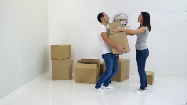 Casal jovem embalagem e realização de caixas de papelão de seu antigo apartamento . — Vídeo de Stock