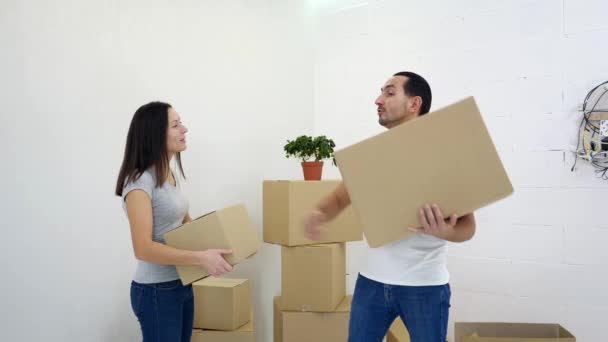 Caucasian couple have a quarrel, moving into new apartment, because dont know where to put all those big cardboard boxes. — Stock Video