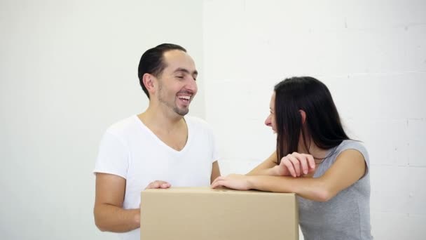 Young couple relocating into a new house and discussing their palns about design and future goals. — Stock Video