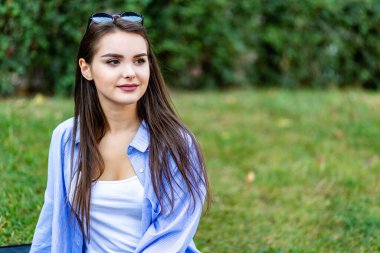 Copyspace portrait, young woman breathing in fresh crisp air, enjoying beauty of nature, isolated outdoors.