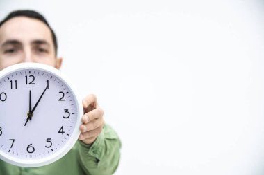 Cropped shot of businessman in a hurry, with clock in hands, trying to stop time, because a deadline is closer. clipart