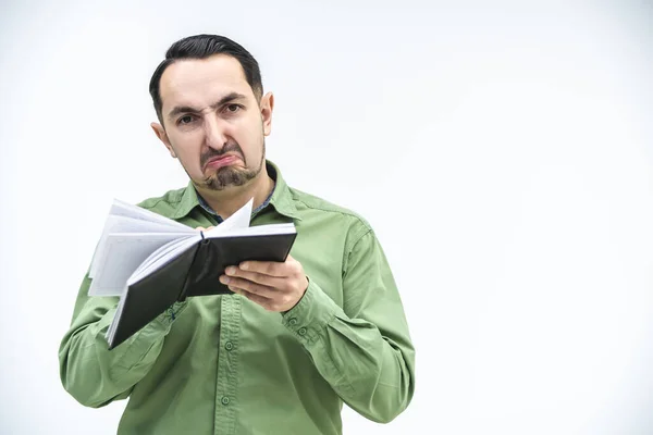 Disappointed young caucasian businessman reading documents, frowning his face, found mistake in report. — Stock Photo, Image