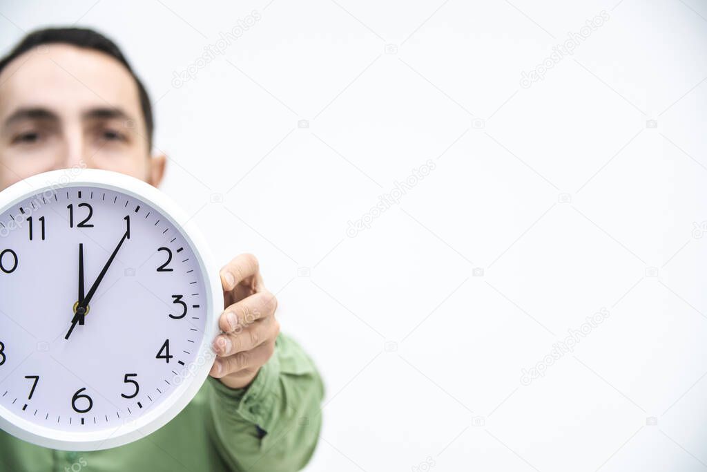Cropped shot of businessman in a hurry, with clock in hands, trying to stop time, because a deadline is closer.