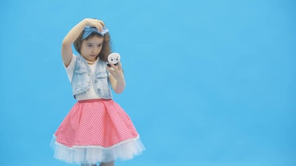 4k відео, де маленька дівчинка робить макіяж і посміхається в кінці . — стокове відео