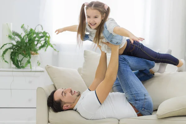 Cute young daughter plays with her dad. — Stock Photo, Image