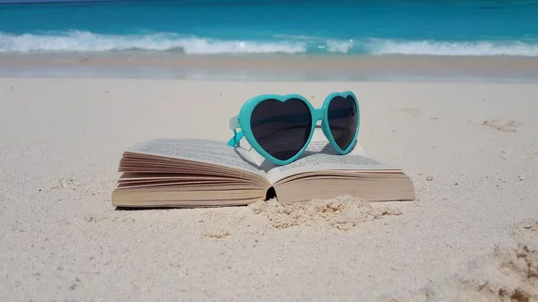 v00005 Maldives beautiful beach background white sandy tropical paradise island with blue sky sea water ocean 4k green sunglasses reading book