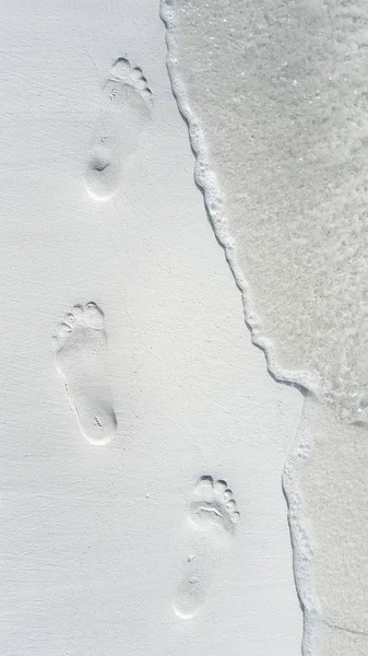 P01652 Maldives white sandy beach footprints on sunny tropical paradise island with aqua blue sky sea ocean 4k