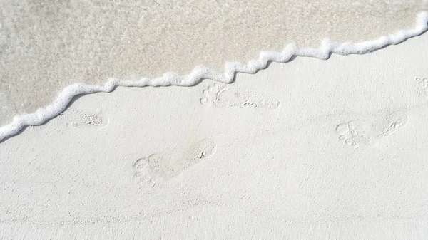 P01642 Maldives white sandy beach footprints on sunny tropical paradise island with aqua blue sky sea ocean 4k