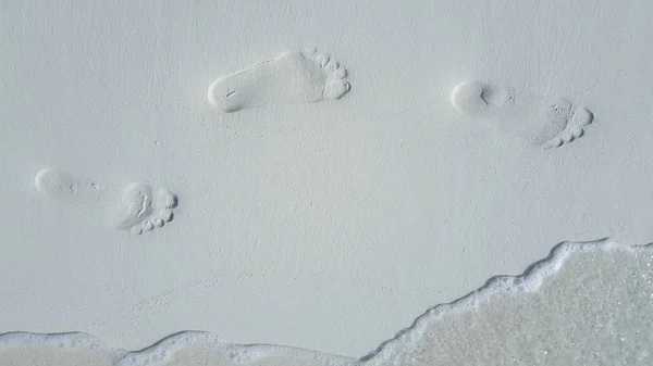 P01663 Maldives white sandy beach footprints on sunny tropical paradise island with aqua blue sky sea ocean 4k