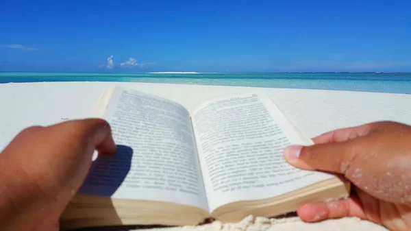 P01442 Maldives white sandy beach reading book on sunny tropical paradise island with aqua blue sky sea ocean 4k