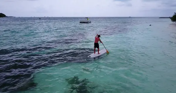 v09317 People enjoying boats and watersports with view from aerial flying drone in clear aqua blue sea water and blue sky