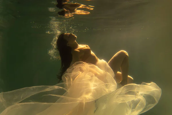 Beautiful Girl Swims Underwater Long Hair Blue Gold Background Gold — Stock Photo, Image