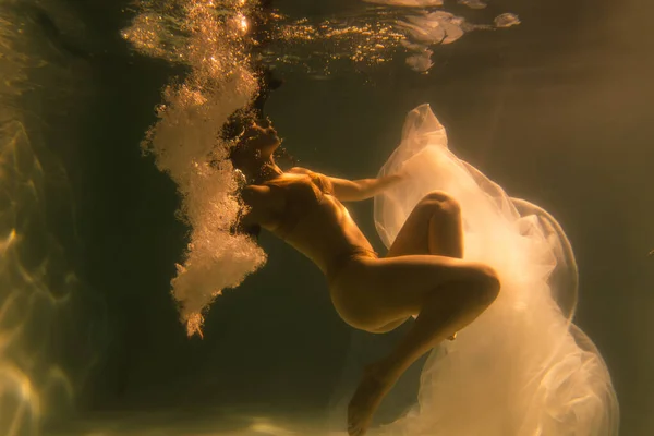 Beautiful Girl Swims Underwater Long Hair Blue Gold Background Gold — Stock Photo, Image