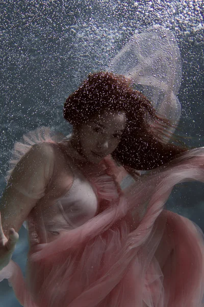 Ein Mädchen Mit Langen Dunklen Haaren Schwimmt Einem Rosa Kleid — Stockfoto