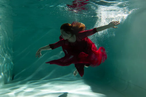 Beautiful Girl Underwater Red Dress Swims Pool Tenderness Elegance Bubbles — Stock Photo, Image