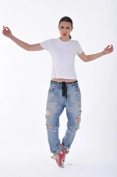 Young girl posing in blue jean pant and white thsirt at studio — Stock fotografie